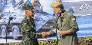 In this photo released by Royal Thai Army, Thailand Chief of Defence Forces General Chalermpol Srisawasdi, left, shakes hands with Commander of the United States Indo-Pacific Command Admiral John Aquilino, during opening ceremony of Cobra Gold 2023 in Rayong Province Thailand, Tuesday, Feb. 28, 2023. Thai and U.S. officials presided over the opening ceremony Tuesday of Cobra Gold 2023, one of the biggest joint multilateral military exercises in the world that pulls together the security interests of the United States and six Asian nations. (Royal Thai Army via AP)