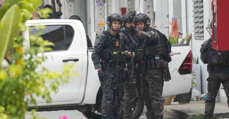 Members of the armed commando police are seen outside a home of a senior police officer in Bangkok, Thailand, Wednesday, March 15, 2023. Thai police on Wednesday detained the senior police officer who fired multiple gunshots from his home in Bangkok, ending a standoff of over 24 hours after his colleagues tried to take him to be treated for mental illness. (AP Photo/Sakchai Lalit)