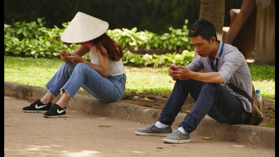 Vietnamese people on phones using social media.