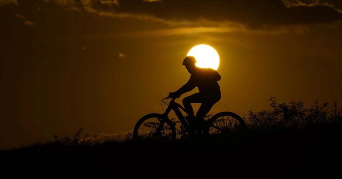 A cyclist tops a hill on a hot day at sunset, Aug 20, 2023, in San Antonio. UN weather agency says Earth sweltered through the hottest summer ever as record heat in August capped a brutal, deadly three months in northern hemisphere (AP Photo/Eric Gay, File)