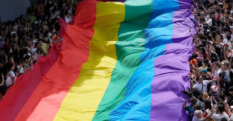 FILE - Participants hold a rainbow flag during a Pride Parade in Bangkok, Thailand, on June 4, 2023. Thailand’s Cabinet on Tuesday, Nov. 21, approved an amendment to its civil code to allow same-sex marriage, with an expectation for the draft to be submitted to Parliament next month. (AP Photo/Sakchai Lalit, File)