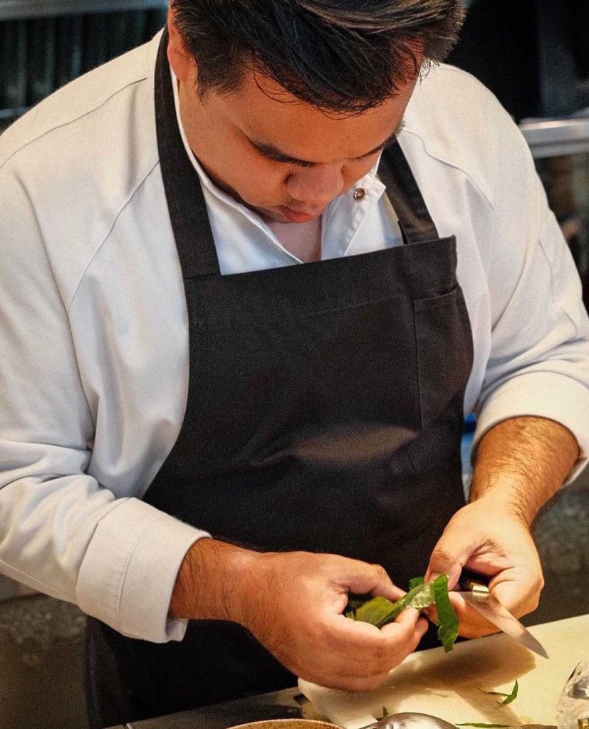 Chef Thav cooking in the kitchen of 80/20 restaurant in Bangkok, Thailand