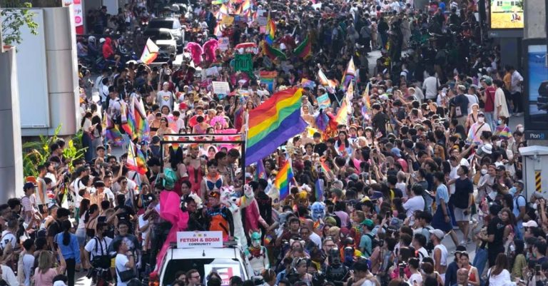 GBTQ community hold rainbow flag in the Pride Parade in Bangkok, Thailand