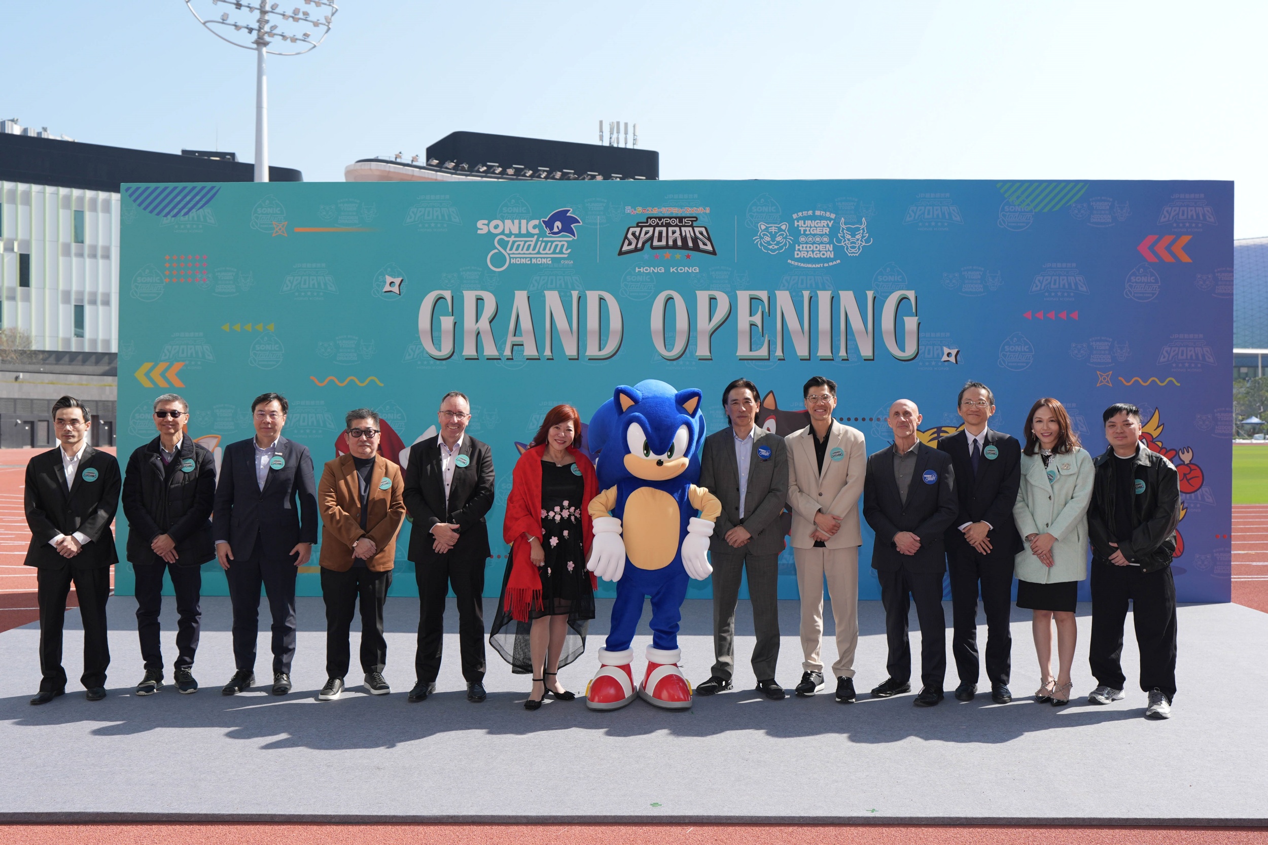 JOYPOLIS SPORTS HONG KONG, held its grand opening ceremony today. SEGA's iconic character, SONIC the Hedgehog, joined all officiating guests to share the joy. From left: Mr Chan Kam-lung, Director representative, Supreme Joy Limited; Mr Alan Ho, Director, Supreme Joy Limited; Mr. Arnold Lau, Associate Director-General of Investment Promotion, InvestHK; Mr Stanley Chan, Director, Supreme Joy Limited and the owner of the legendary Hong Kong racehorse "Golden Sixty"; Mr John Sharkey, Project Director, Kai Tak Sports Park Limited; Dr Bonnie Or, Director, Supreme Joy Limited; Mr Shuji Utsumi, President and COO of SEGA CORPORATION; Mr Vincent Law, Executive Director, Supreme Joy Limited; Mr. Justin Scarpone, Executive Vice President, Executive Officer and Head of Global Transmedia Group of SEGA; Mr. Nishiumi Shigehiro, Deputy Consul-General of Japan, Consulate-General of Japan in Hong Kong; Mrs Alice Law, Managing Director, Supreme Joy Limited and Mr. Keo. W of “Hungry Tiger Hidden Dragon”.