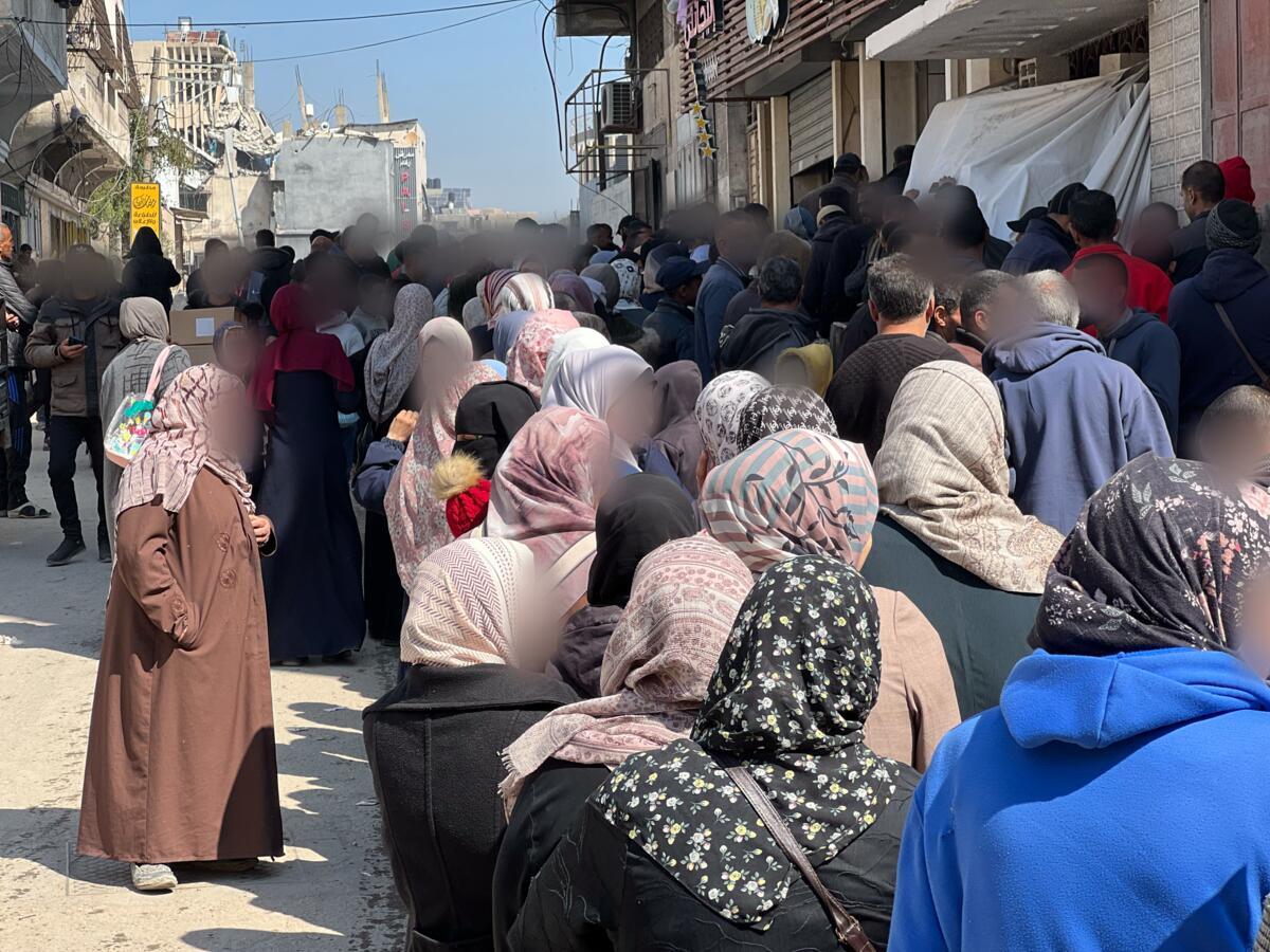 Families in Gaza wait to receive clothing aid (Shaima Al-Obaidi, Save the Children; February 27, 2025)