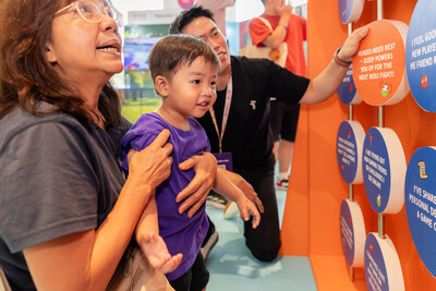 A family interacting with the “Stay in Control Flip Board” installation created by Tencent. A family interacting with the “Stay in Control Flip Board” installation created by Tencent.