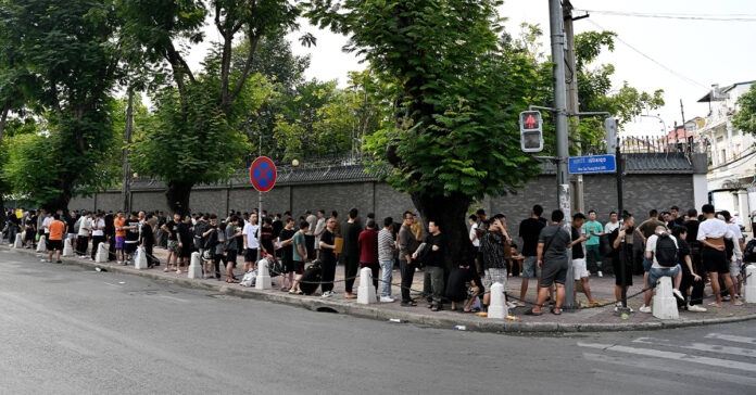 People line up in front of the Chinese Embassy in Phnom Penh on January 19, 2026. More than 400 Indonesians were freed by cyberscam networks in Cambodia this month, Jakarta said on January 19, after Phnom Penh announced a fresh crackdown on the illicit industry following the arrest of a prominent alleged boss. About 100 people were also queuing outside the Chinese embassy in Phnom Penh on the afternoon of January 19, but those approached by an AFP journalist declined to speak.