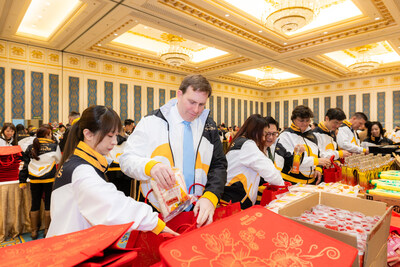 Patrick Dumont (second from left), president and chief operating officer of Las Vegas Sands, together with the company’s management team, participates in assembling Chinese New Year festive kits Feb. 3. The team worked together to assemble more than 20,000 staple foods and essential items.