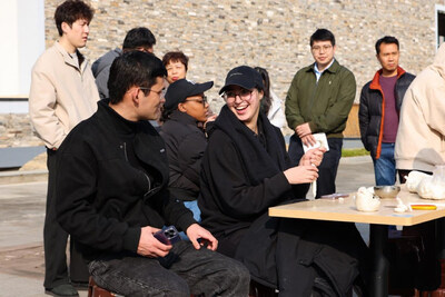 Foreign tourists make rice cakes in Tengtou village before the Chinese New Year.