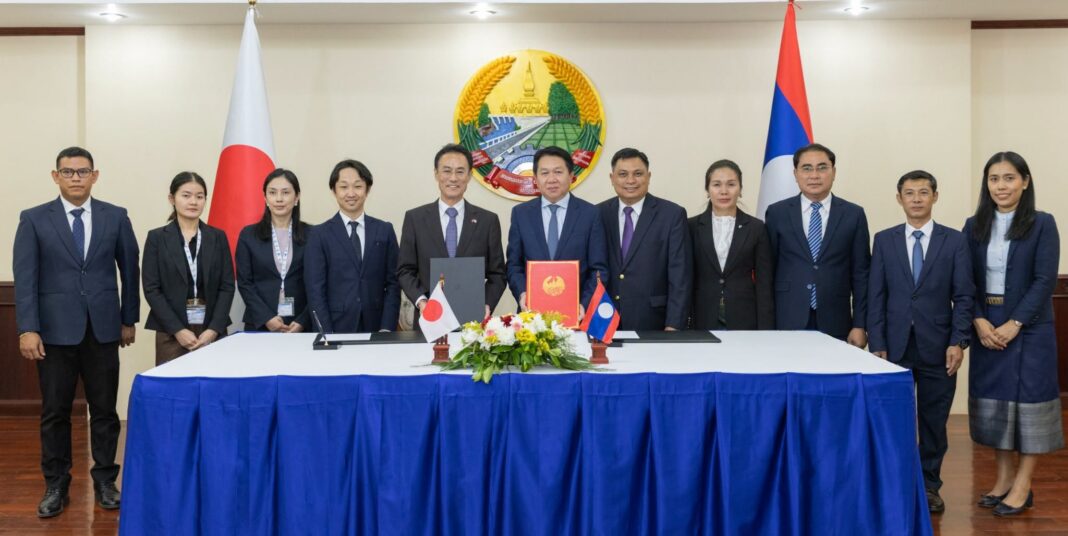 Lao and Japanese officials attending a scholarship grant signing ceremony for Lao civil servants.