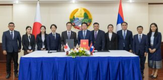 Lao and Japanese officials attending a scholarship grant signing ceremony for Lao civil servants.