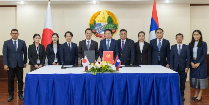 Lao and Japanese officials attending a scholarship grant signing ceremony for Lao civil servants.