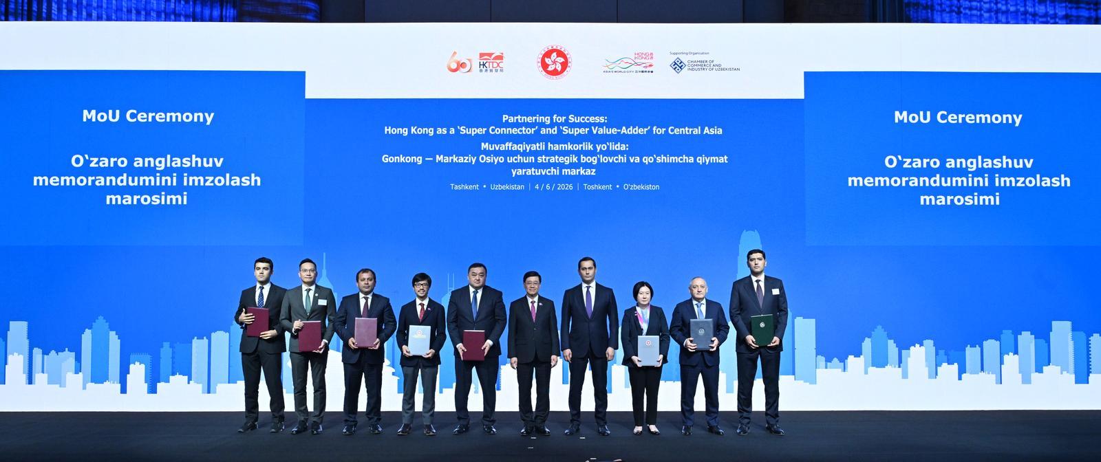 Hong Kong SAR's Chief Executive, John Lee (fifth right) and the Advisor to the President of Uzbekistan on Strategic Development, Sardor Umurzakov (fourth right) witness the exchange of memoranda of understanding and co-operation agreements between government departments, enterprises and organisations from Hong Kong and Uzbekistan.