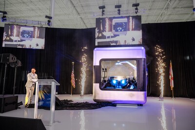 AMPERA Founder and CEO Brian Matthews pulls curtain revealing the first full-scale 3D printed reactor module, featuring a fully 3D printed silicon carbide reactor core and reactor pressure vessel at a celebratory event at the company&rsquo;s innovation center in Palm Beach Gardens, Fla.